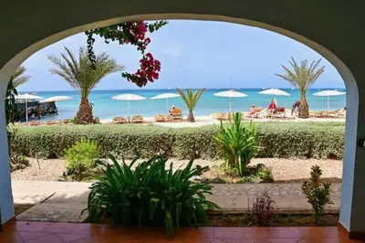 a view of a beach with umbrellas and the ocean at Porto Antigo II Ocean Appartment in Santa Maria