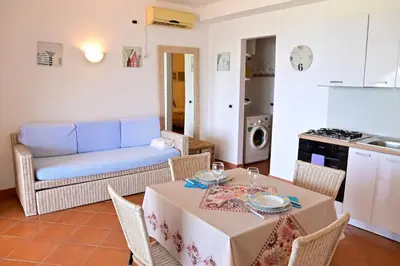 a living room with a table and a couch at Porto Antigo II Ocean Appartment in Santa Maria
