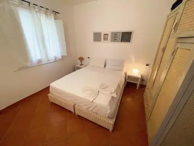 a bedroom with a white bed and a window at Porto Antigo II Ocean Appartment in Santa Maria