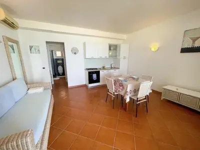a kitchen and dining room with a table and chairs at Porto Antigo II Ocean Appartment in Santa Maria