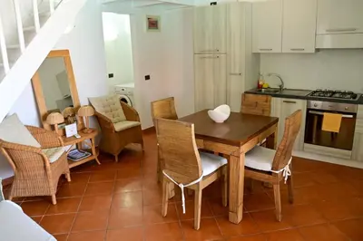 a kitchen and dining room with a table and chairs at Porto Antigo II Poolside Appartment in Santa Maria