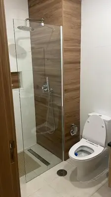 a bathroom with a toilet and a glass shower at Condomínio Horizonte in Praia