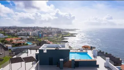 a view of the ocean from a house with a swimming pool at Condomínio Horizonte in Praia