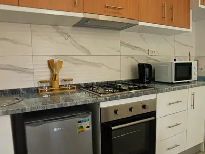 a kitchen with a stove top oven next to a microwave at Casabeleza Cape Verde in Assomada