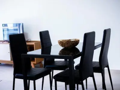 a dining room table with black chairs and a basket on it at Casabeleza Cape Verde in Assomada