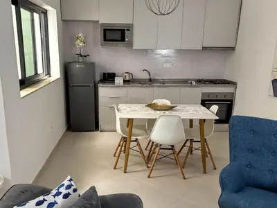 a kitchen with a table and chairs in a room at Tarrafal Bay - 1Bdr Apt - 3 in Tarrafal