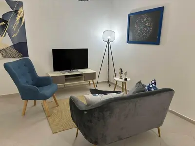 a living room with a couch and a chair and a television at Tarrafal Bay - 1Bdr Apt - 3 in Tarrafal