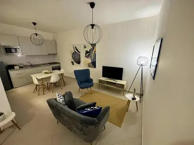 a living room with a couch and a table with chairs at Tarrafal Bay - 1Bdr Apt - 3 in Tarrafal