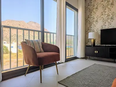 a living room with a chair and a large window at Tarrafal Bay - 1Bdr Apt - Sea view - 4 in Tarrafal