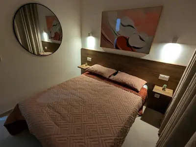 a bedroom with a bed and a large mirror at Tarrafal Bay - 1Bdr Apt - Sea view - 4 in Tarrafal