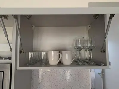 a shelf with glasses and wine glasses on it at Tarrafal Bay - 1Bdr Apt - Sea view - 4 in Tarrafal