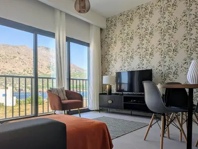 a bedroom with a bed and a tv and a balcony at Tarrafal Bay - 1Bdr Apt - Sea view - 4 in Tarrafal