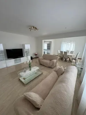 a living room with a couch and a table at Casa Carveiros Panoramic 360 in Tarrafal