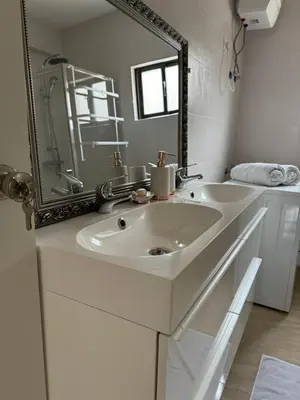 a bathroom with a white sink and a mirror at Casa Carveiros Panoramic 360 in Tarrafal