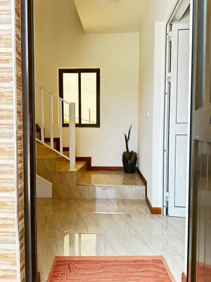 a staircase in a home with white walls and wood floors at Casa Carveiros Panoramic 360 in Tarrafal