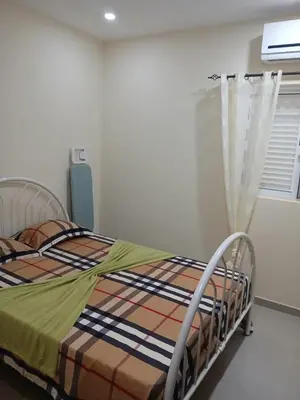 a hospital bed in a room with a window at Suites Home Tarrafal in Tarrafal