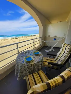 a balcony with a table and chairs and the beach at Blu Jasmine in Sal Rei