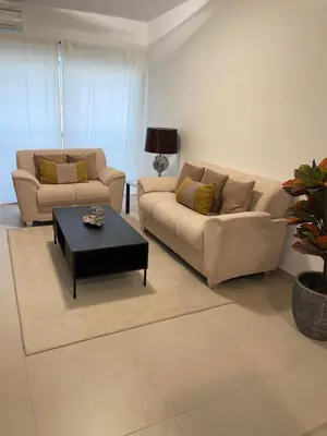 a living room with two couches and a coffee table at Prainha Beach Apartment I in Praia