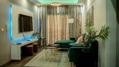 a living room with a green couch and a table at Prainha Beach Apartment I in Praia