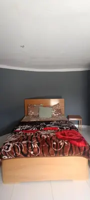 a bedroom with a large bed with a wooden frame at Casa Mamã in Portela