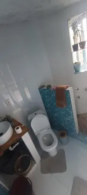 a bathroom with a toilet and a sink at Casa Mamã in Portela