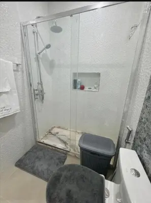 a bathroom with a glass shower and a toilet at Peace of mind in Praia
