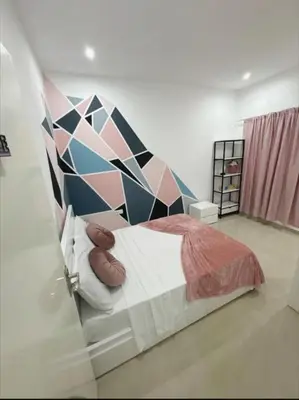 a bedroom with a bed with a geometric wall at Peace of mind in Praia