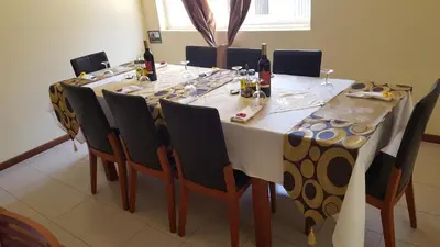 a long table with chairs and bottles of wine at Hotel Lazareto in Mindelo