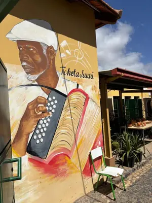 a mural of a man holding a remote control at Techas Family Beach Stay 3BR in Central Tarrafal in Tarrafal