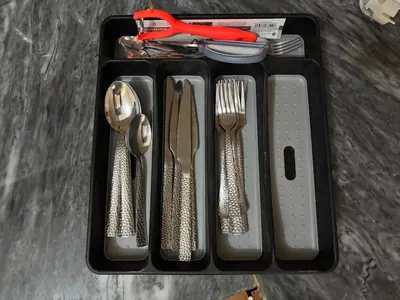 a black tray with silver utensils on a table at Techas Family Beach Stay 3BR in Central Tarrafal in Tarrafal