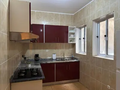 a kitchen with a sink and a stove at Techas Family Beach Stay 3BR in Central Tarrafal in Tarrafal