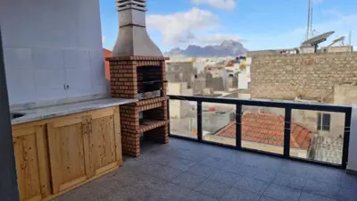 a balcony with a brick oven with a view at Casa Maré & Museu - Porta Nº 18 in Mindelo
