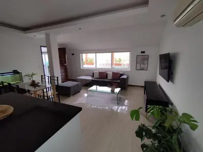 a living room with a couch and a table at Apartamento T1, amplo e arrejado in Praia