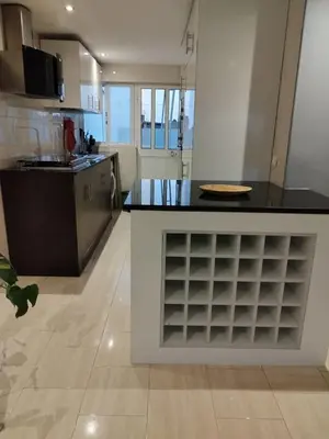 a kitchen with a island with a counter top at Apartamento T1, amplo e arrejado in Praia