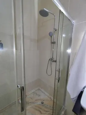 a shower with a glass door in a bathroom at Apartamento T1, amplo e arrejado in Praia