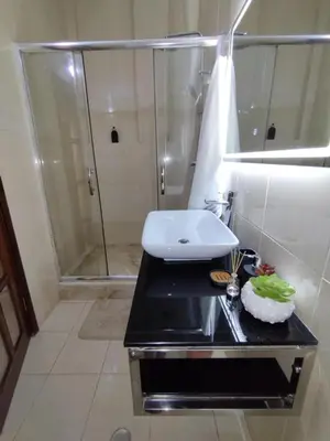 a bathroom with a sink and a shower at Apartamento T1, amplo e arrejado in Praia