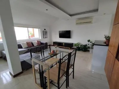a living room with a table and a couch at Apartamento T1, amplo e arrejado in Praia