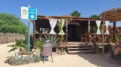 a restaurant on the beach with a sign in front of it at Apartment Boadventure in Sal Rei