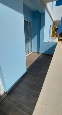 a room with a blue wall and a balcony at Apartment Boadventure in Sal Rei