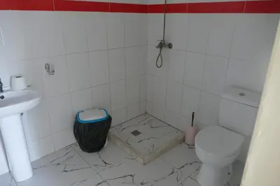 a bathroom with a toilet and a sink at Magei in Tarrafal