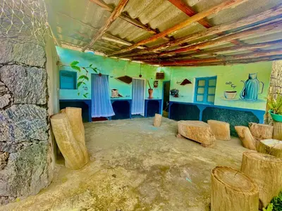 a room with some logs and chairs in it at Pensão Rilda Montrond in Portela