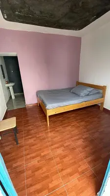 a bedroom with a bed and a wooden floor at Pensão Rilda Montrond in Portela