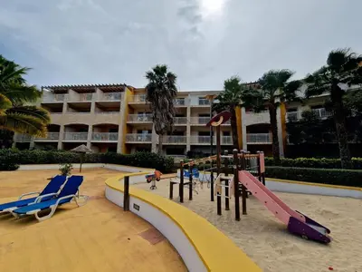 a resort with a playground with a slide and slides at Stay, laugh, repeat! in Prainha