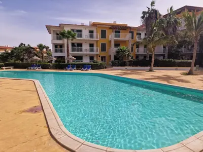 a large swimming pool in front of a building at Stay, laugh, repeat! in Prainha