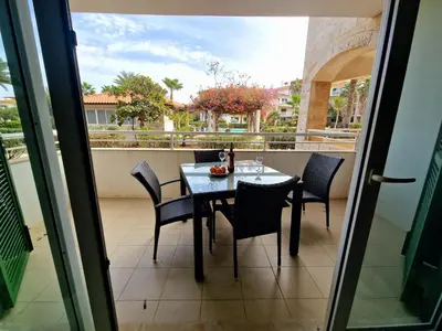 a dining table and chairs on a balcony with a view at Stay, laugh, repeat! in Prainha