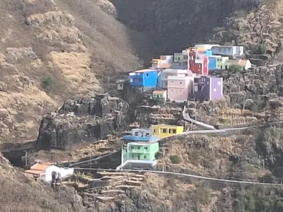 a group of houses on the side of a mountain at Casa Larinha in Ponta do Sol