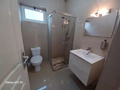 a bathroom with a shower and a toilet and a sink at Casa Larinha in Ponta do Sol
