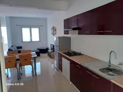 a kitchen with brown cabinets and a counter top at Casa Larinha in Ponta do Sol