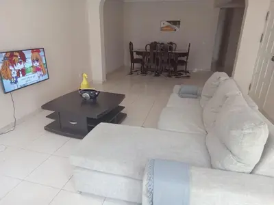 a living room with a white couch and a table at Morabeza Praia in Praia