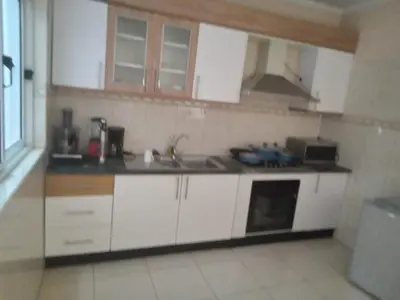 a small kitchen with white cabinets and a sink at Morabeza Praia in Praia
